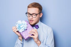 Closeup portrait of happy excited young man with colorful gift box. Present, birthday, Valentine stock photo Closeup portrait of happy excited young man with colorful gift box. Present, birthday, Valentine stock photo