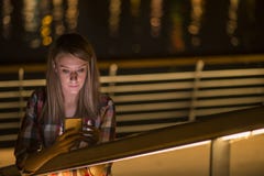 Closeup portrait young unhappy teen woman, talking on cell phone Stock Photo Closeup portrait young unhappy teen woman, talking on cell phone Stock Photo