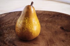 Closeup ripe pears on a wooden vintage plate on the table, sweet fruit dessert, autumn harvest, diet products, place for text stock images Closeup ripe pears on a wooden vintage plate on the table, sweet fruit dessert, autumn harvest, diet products, place for text stock images