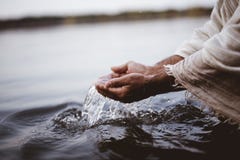 Closeup Shot Of A Person`s Hands Holding Water With A Blurred Background Royalty Free Stock Photography