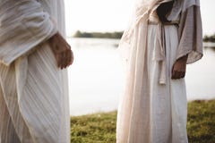 Closeup shot of two people wearing a biblical robe with a blurred background