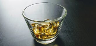 Closeup shot of yellow drugs bunch- perfect for omega-3, fish oil concepts