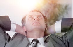 Closeup .a successful businessman relaxarea sitting behind a Desk royalty free stock images Closeup .a successful businessman relaxarea sitting behind a Desk royalty free stock images