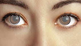 Closeup woman face with hypnotized eyes animation