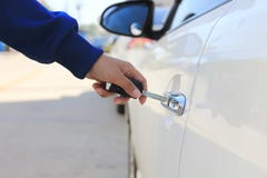 Closeup Women hand holding car key to unlocking or opening car door stock image Closeup Women hand holding car key to unlocking or opening car door stock image