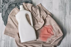 Clothes with stains and a bottle of detergent. Top view royalty free stock images Clothes with stains and a bottle of detergent. Top view royalty free stock images