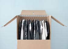 Clothes in a wardrobe box for easy moving Royalty Free Stock Image Clothes in a wardrobe box for easy moving Royalty Free Stock Image