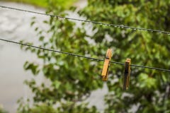 Clothespins hanging on the street after the rain on them drops stock image Clothespins hanging on the street after the rain on them drops stock image