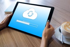 Cloud synchronization progress bar on tablet screen. Data storage and protection. Technology and internet concept. stock photo Cloud synchronization progress bar on tablet screen. Data storage and protection. Technology and internet concept. stock photo