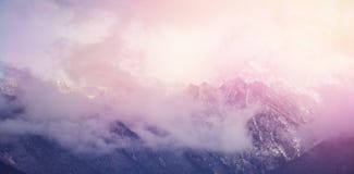 Clouds covering snowcapped mountains against sky. Scenic view of clouds covering snowcapped mountains against sky Stock Photography Clouds covering snowcapped mountains against sky. Scenic view of clouds covering snowcapped mountains against sky Stock Photography