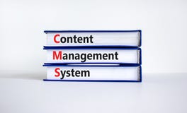 CMS content management system symbol. Concept words CMS content management system on books on a beautiful white table, white