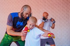 The coach teaches the boy kick Boxing stock image The coach teaches the boy kick Boxing stock image