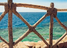Coast of the Red Sea with a wooden fence and sun umbrellas in Sharm El Sheikh, Egypt royalty free stock photos Coast of the Red Sea with a wooden fence and sun umbrellas in Sharm El Sheikh, Egypt royalty free stock photos