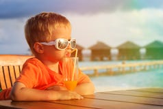 Cocktail bevente del ragazzino sulla spiaggia tropicale