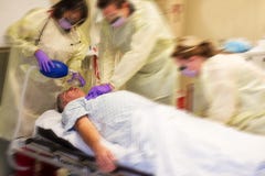 Code blue team resuscitating a patient. Code blue team doing CPR on a patient in a hospital room Code blue team resuscitating a patient. Code blue team doing CPR on a patient in a hospital room