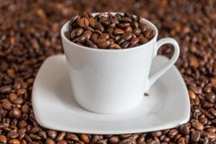Coffee beans in and around a cup stock images Coffee beans in and around a cup stock images