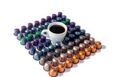 Coffee capsules different colors and white cup of hot black coffee on white background isolated royalty free stock photos Coffee capsules different colors and white cup of hot black coffee on white background isolated royalty free stock photos