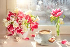 Coffee cup, pink tulips and white freesia - on the window board, springtime background stock photos Coffee cup, pink tulips and white freesia - on the window board, springtime background stock photos