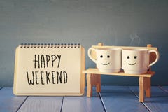 coffee cups next to notebook with phrase happy weekend royalty free stock images coffee cups next to notebook with phrase happy weekend royalty free stock images