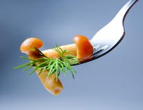 Cogumelos postos de conserva deliciosos em uma forquilha decorada com um ramo do aneto Fundo para um cartão do convite ou umas fe fotografia de stock Cogumelos postos de conserva deliciosos em uma forquilha decorada com um ramo do aneto Fundo para um cartão do convite ou umas fe fotografia de stock