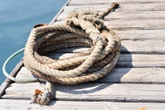 Coiled marine rope on wooden pier royalty free stock photo Coiled marine rope on wooden pier royalty free stock photo