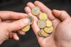 Coins in hand. Hands counting a few euro coins. A hand of coins in the palm. Economic crisis. Coins in the palm. Money in hand.