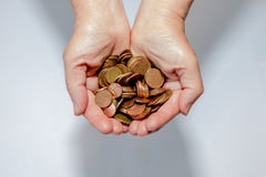 Coins in hands. On a white and grey background royalty free stock images Coins in hands. On a white and grey background royalty free stock images
