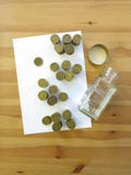 Coins from the glass money box on the tabe royalty free stock photos Coins from the glass money box on the tabe royalty free stock photos