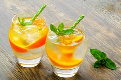 Cold drinks with ice and mint. Orange cocktail on stock photos Cold drinks with ice and mint. Orange cocktail on stock photos