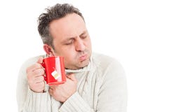 Cold man holding tea mug and shivering Royalty Free Stock Image Cold man holding tea mug and shivering Royalty Free Stock Image