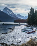 Cold morning with snow covering canoes in maligne lake, alberta, canada stock image Cold morning with snow covering canoes in maligne lake, alberta, canada stock image