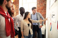 Collaboration is a key to best results. Group of young modern people in smart casual wear planning business strategy stock photography Collaboration is a key to best results. Group of young modern people in smart casual wear planning business strategy stock photography