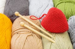 Handmade red heart and skeins of yarn for knitting. The concept of comfort and love Stock Photos Handmade red heart and skeins of yarn for knitting. The concept of comfort and love Stock Photos