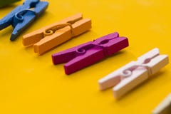 Colored clothespins on a yellow background royalty free stock photos Colored clothespins on a yellow background royalty free stock photos