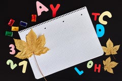Colored letters, paints, autumn leaves and blank sheet of notebook on the black background stock image Colored letters, paints, autumn leaves and blank sheet of notebook on the black background stock image