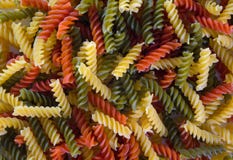 Colored pasta in the form of a spiral. Close-up. Multicolored italian pasta stock photo Colored pasta in the form of a spiral. Close-up. Multicolored italian pasta stock photo