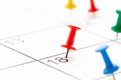 Colored push pin on white calendar background. Copy space for text. stock photography Colored push pin on white calendar background. Copy space for text. stock photography