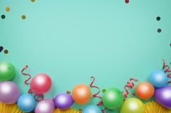 Colorful balloons and confetti on turquoise table top view. Birthday, holiday or party background. Flat lay style. Empty space for