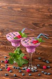 Colorful berry smoothies on a wooden background. Healthy cold milkshake with blueberries, mint, raspberries. Copy space. stock photo Colorful berry smoothies on a wooden background. Healthy cold milkshake with blueberries, mint, raspberries. Copy space. stock photo