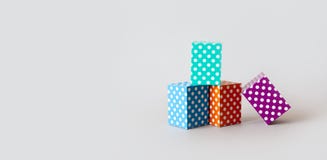 Colorful blocks polka dot pattern. Violet green orange blue color rectangular abstract boxes arranged on gray background stock images Colorful blocks polka dot pattern. Violet green orange blue color rectangular abstract boxes arranged on gray background stock images