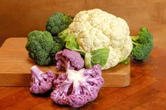 Colorful Cauliflower and Broccoli on cutting board royalty free stock photos Colorful Cauliflower and Broccoli on cutting board royalty free stock photos