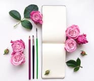 Colorful composition with sketchbook, roses and pencils. Flat lay stock photos Colorful composition with sketchbook, roses and pencils. Flat lay stock photos