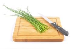 Chives with table knife and cutting board on white Stock Photography Chives with table knife and cutting board on white Stock Photography