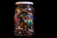 Colorful Israeli, middle-eastern souvenir, an artisan camel garland, stowed away in a jar for a showpiece at home. Isolated on a royalty free stock photo Colorful Israeli, middle-eastern souvenir, an artisan camel garland, stowed away in a jar for a showpiece at home. Isolated on a royalty free stock photo