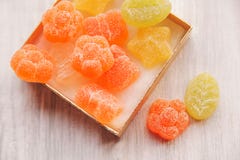 Colorful jelly candy in golden present box.white wooden table.to Royalty Free Stock Images Colorful jelly candy in golden present box.white wooden table.to Royalty Free Stock Images