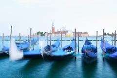Row of gondolas parked on city pier Stock Photos Row of gondolas parked on city pier Stock Photos