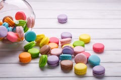 Colorful macaroons or macarons are poured out of the crystal vase on a white background. French sweets royalty free stock photos Colorful macaroons or macarons are poured out of the crystal vase on a white background. French sweets royalty free stock photos