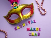 Colorful mardi gras or carnivale mask on a purple background. Venetian masks. top view. stock photo Colorful mardi gras or carnivale mask on a purple background. Venetian masks. top view. stock photo