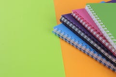 colorful notebooks on a bright green and orange background. stationery. with place for inscription stock image colorful notebooks on a bright green and orange background. stationery. with place for inscription stock image