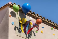 Colorful party balloons decoration on the windows of a building stock photos Colorful party balloons decoration on the windows of a building stock photos
